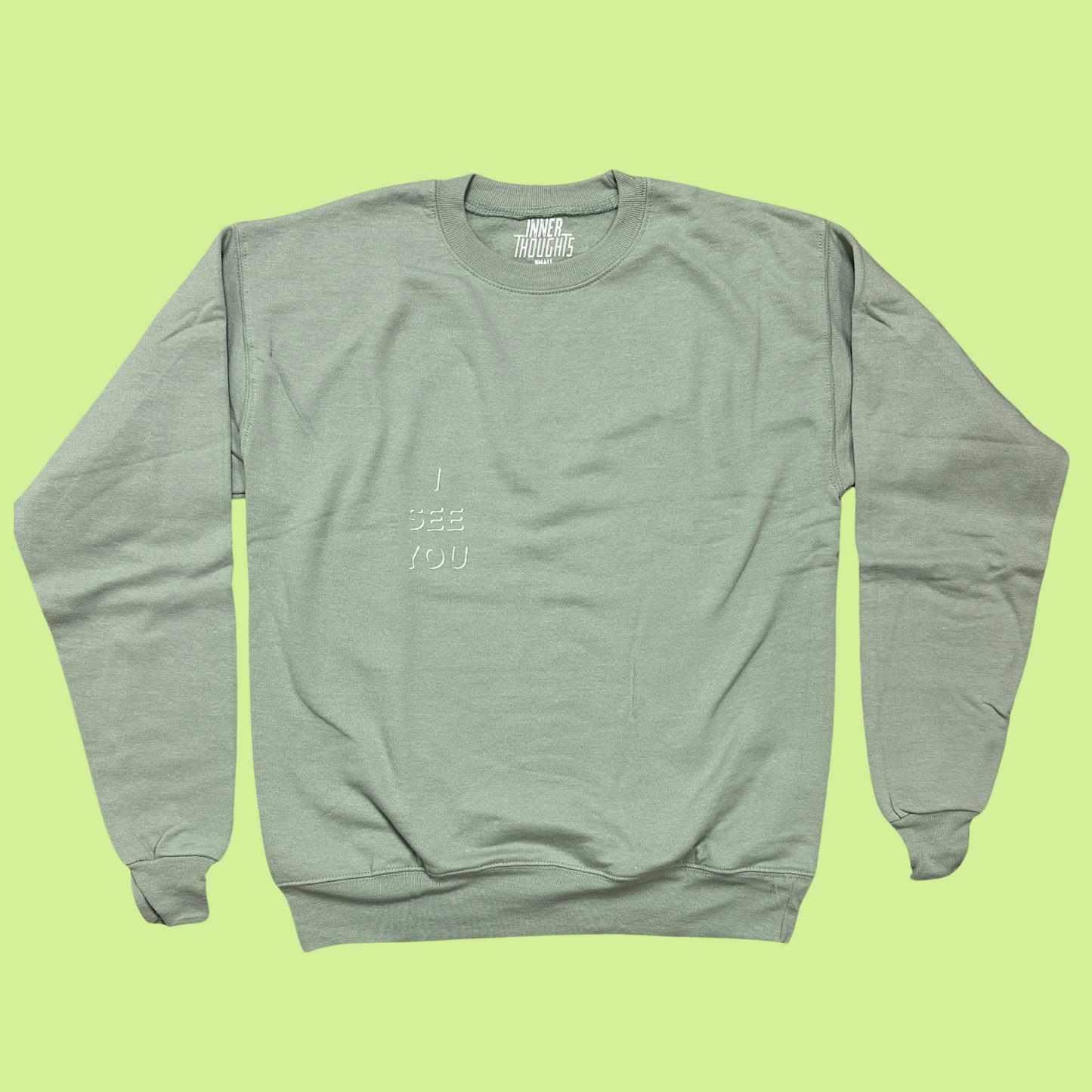 Sage Green Crewneck Sweatshirt with white "I See You" design on the left pocket area