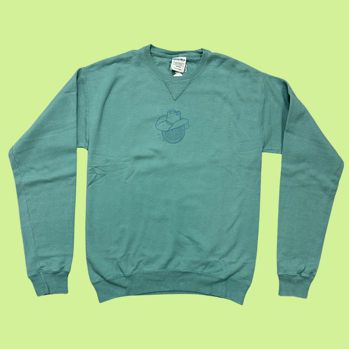 cyprus green crewneck sweatshirt with a disco ball in a cowboy hat printed on the front in a teal blue color