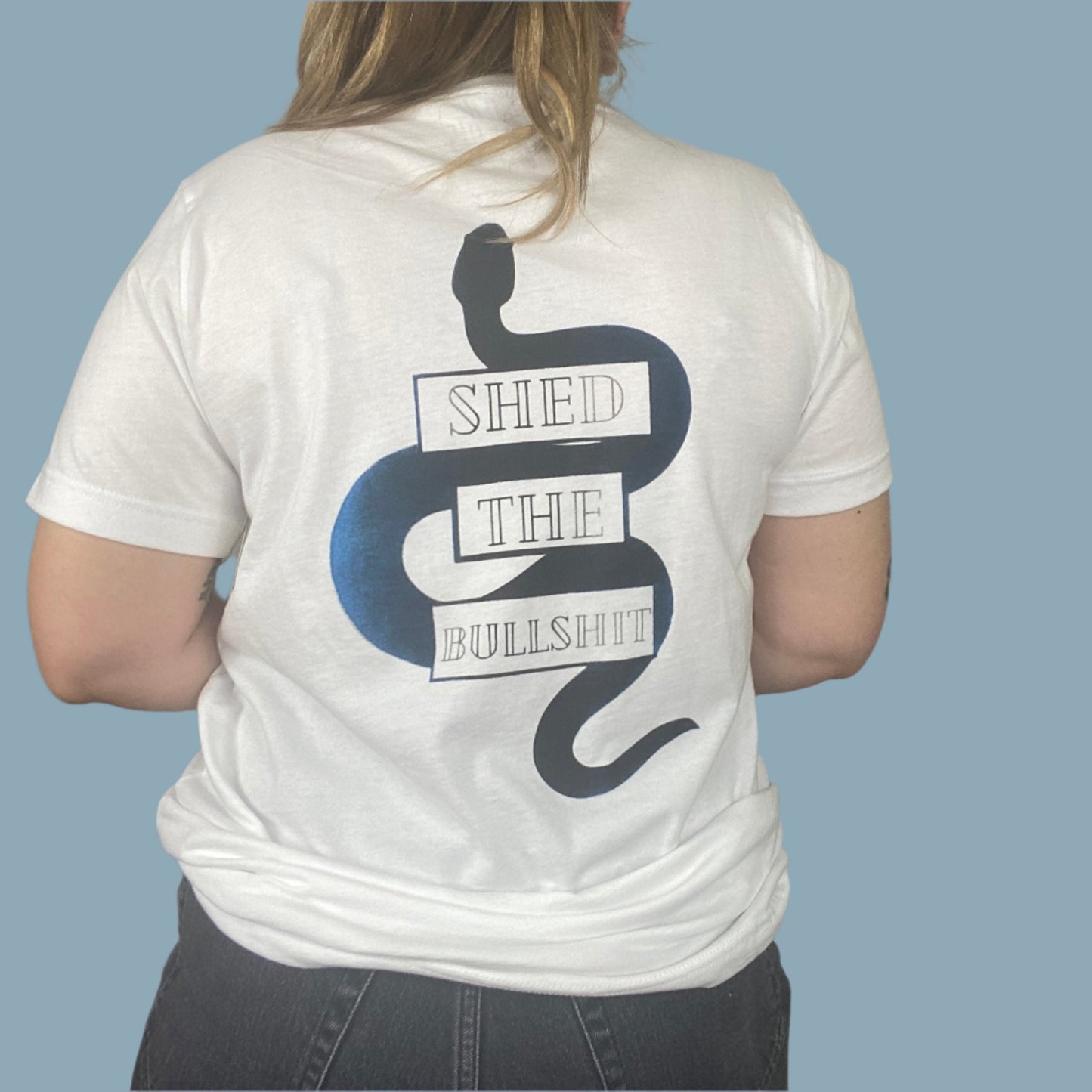 White shirt with the Shed The Bullshit design with blue areas that look faded in and out