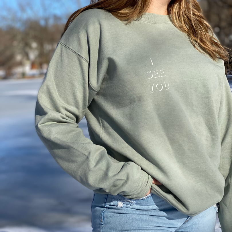 Sage Green Crewneck Sweatshirt with white "I See You" design on the left pocket area