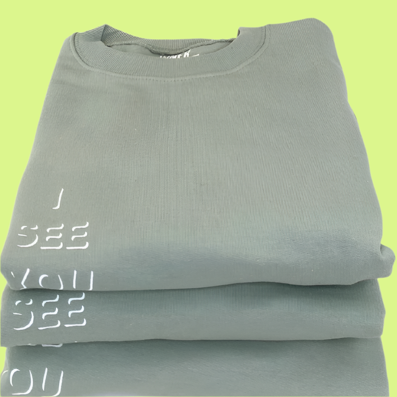 Sage Green Crewneck Sweatshirt with white "I See You" design on the left pocket area; three stacked on top of each other