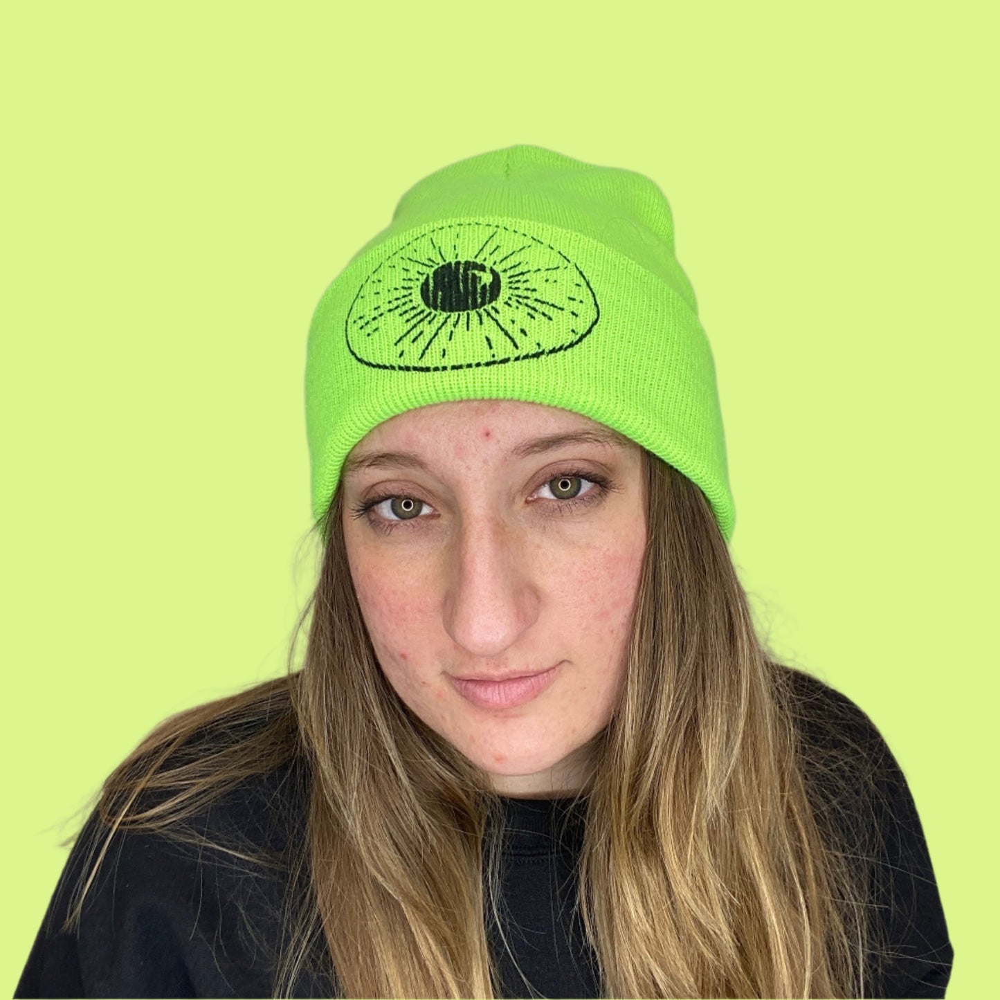 Lime Green Beanie with Night Sky Print on front fold being worn