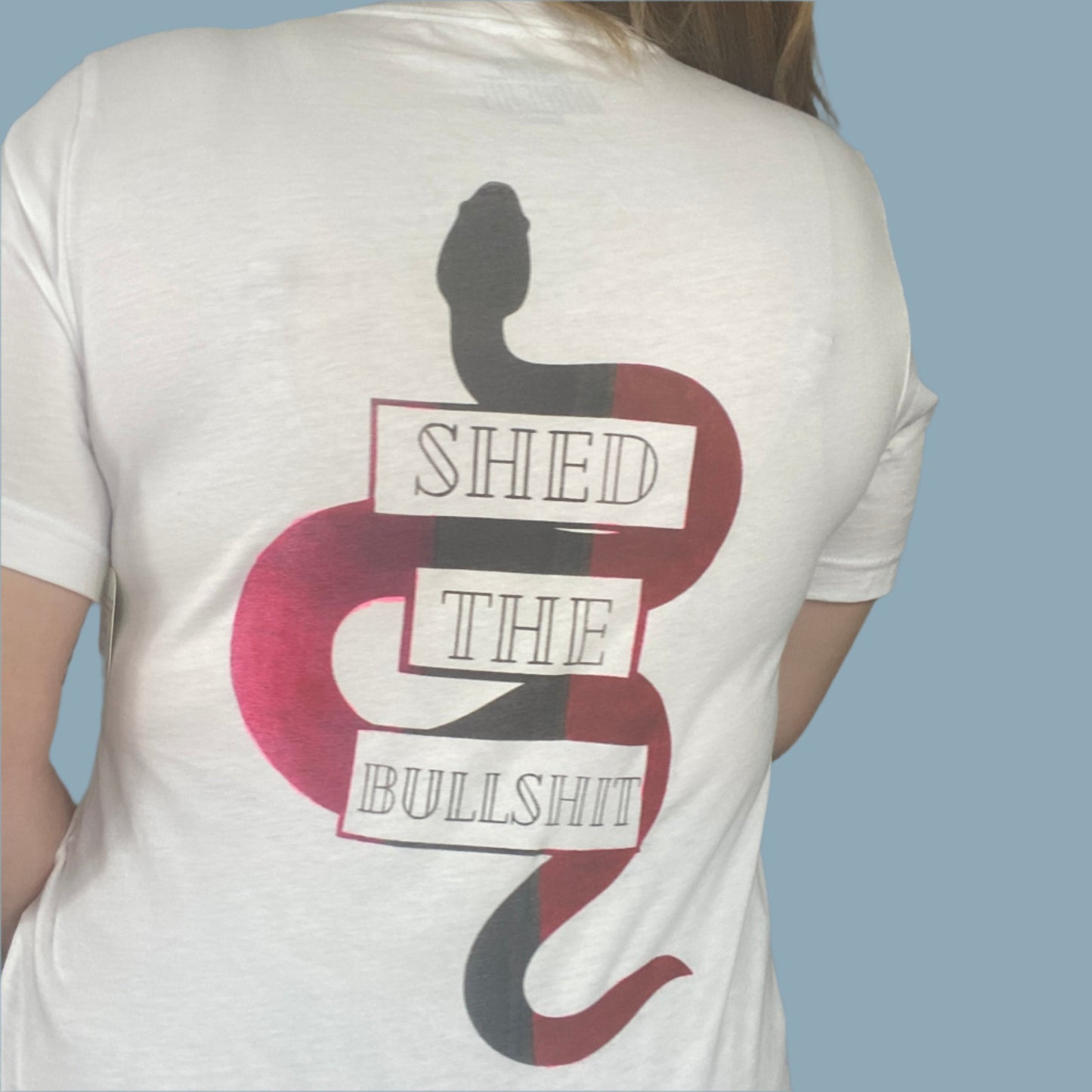 Plain white tee with "Shed the Bullshit" print on the back with Pink faded areas on the snake