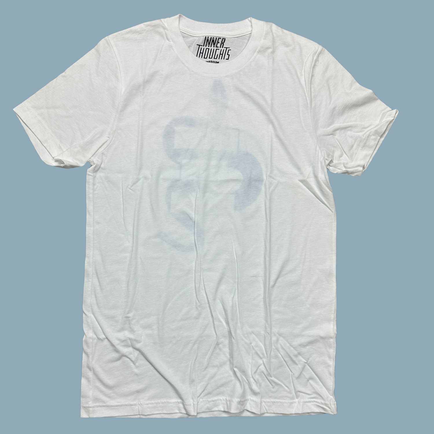 White shirt with the Shed The Bullshit design with blue areas that look faded in and out