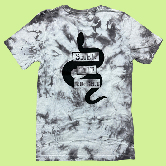 Gray and White tie dye shirt with a snake design on the back with the words "shed the bullshit" in front of the snake