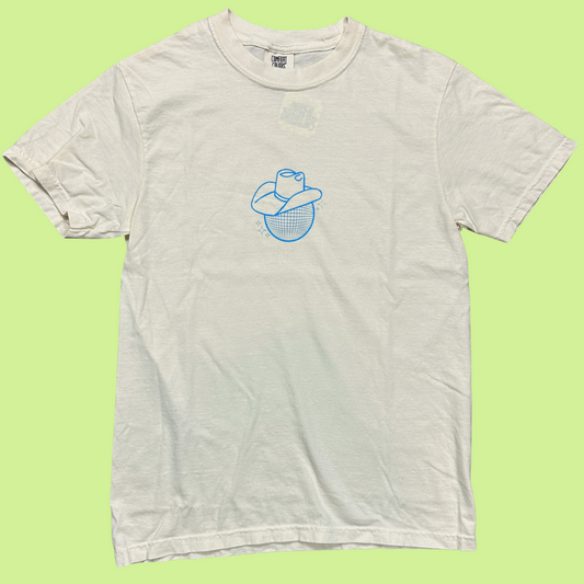 ivory comfort colors crewneck shirt with a disco ball in a cowboy hat printed on the front in a light blue color