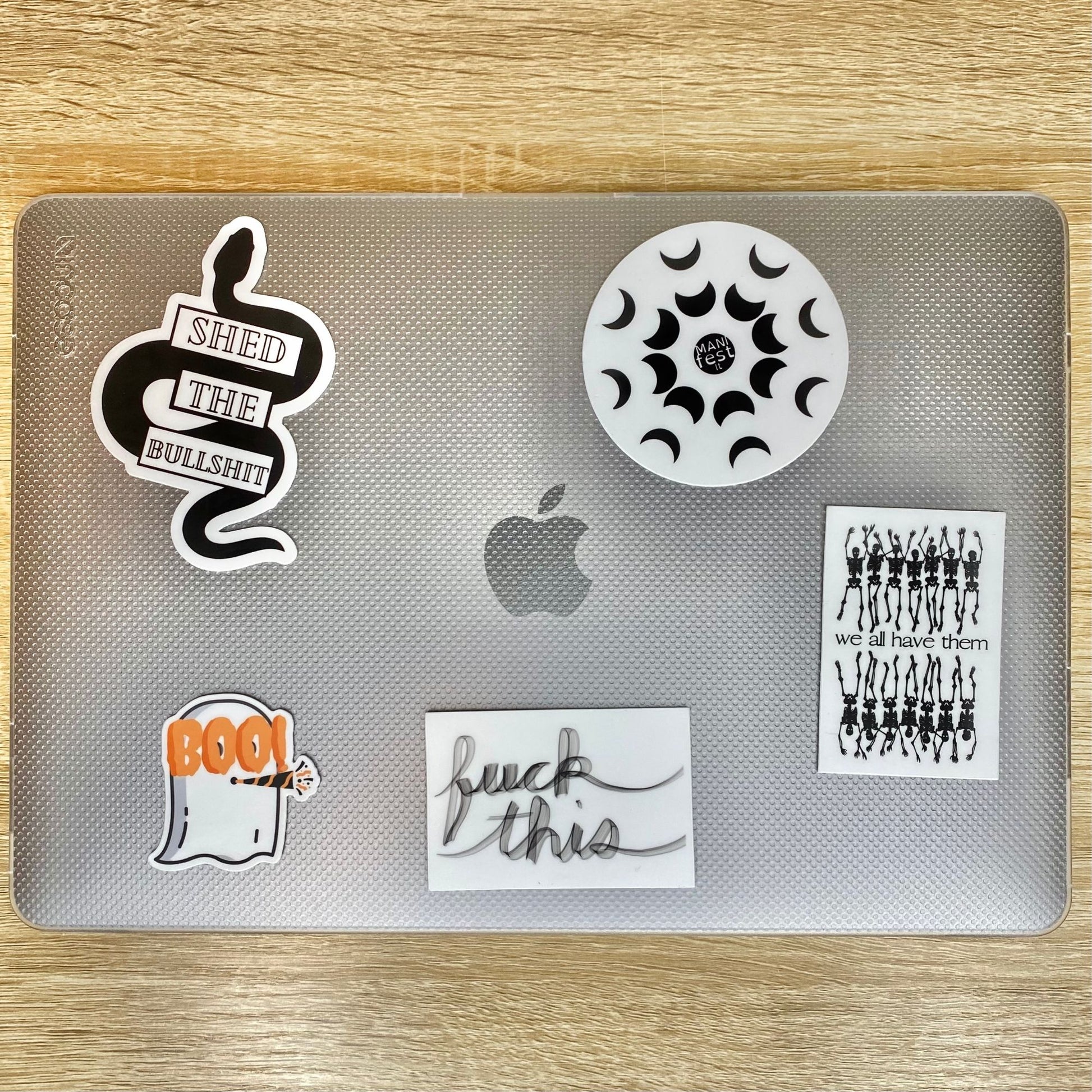 Ghost Party Sticker on a 13 Inch MacBook Air for size Reference. Also shown: Shed the Bullshit, Manifest It, Fuck This and We All Have Them Skeletons Stickers